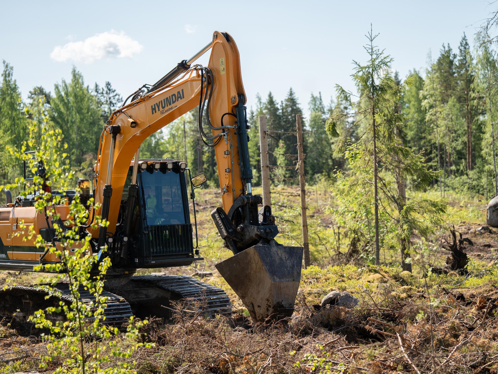 An excavator performing inverting, photo shot from the air.