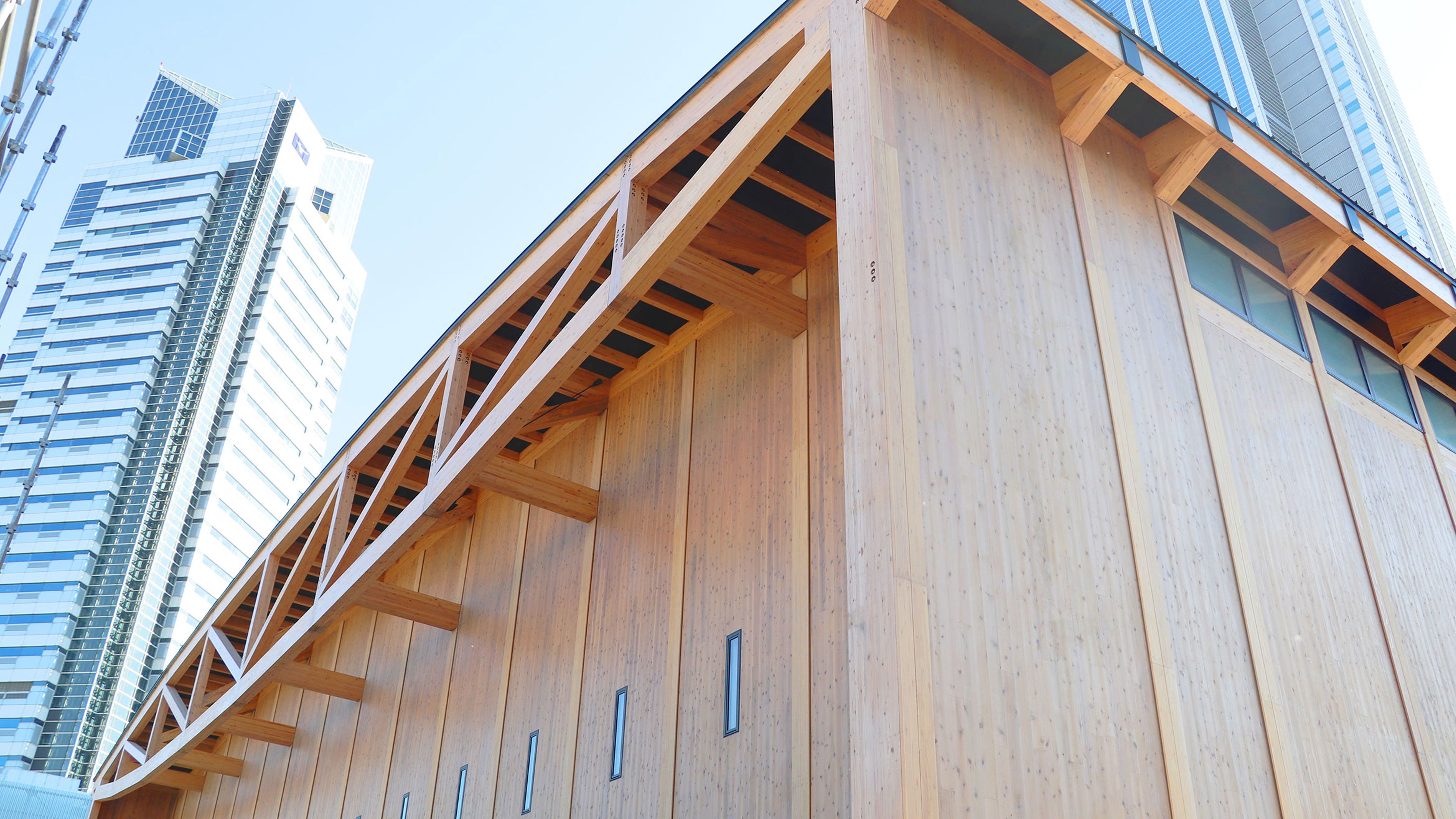 Timber building surrounded by sky scrapers in the city