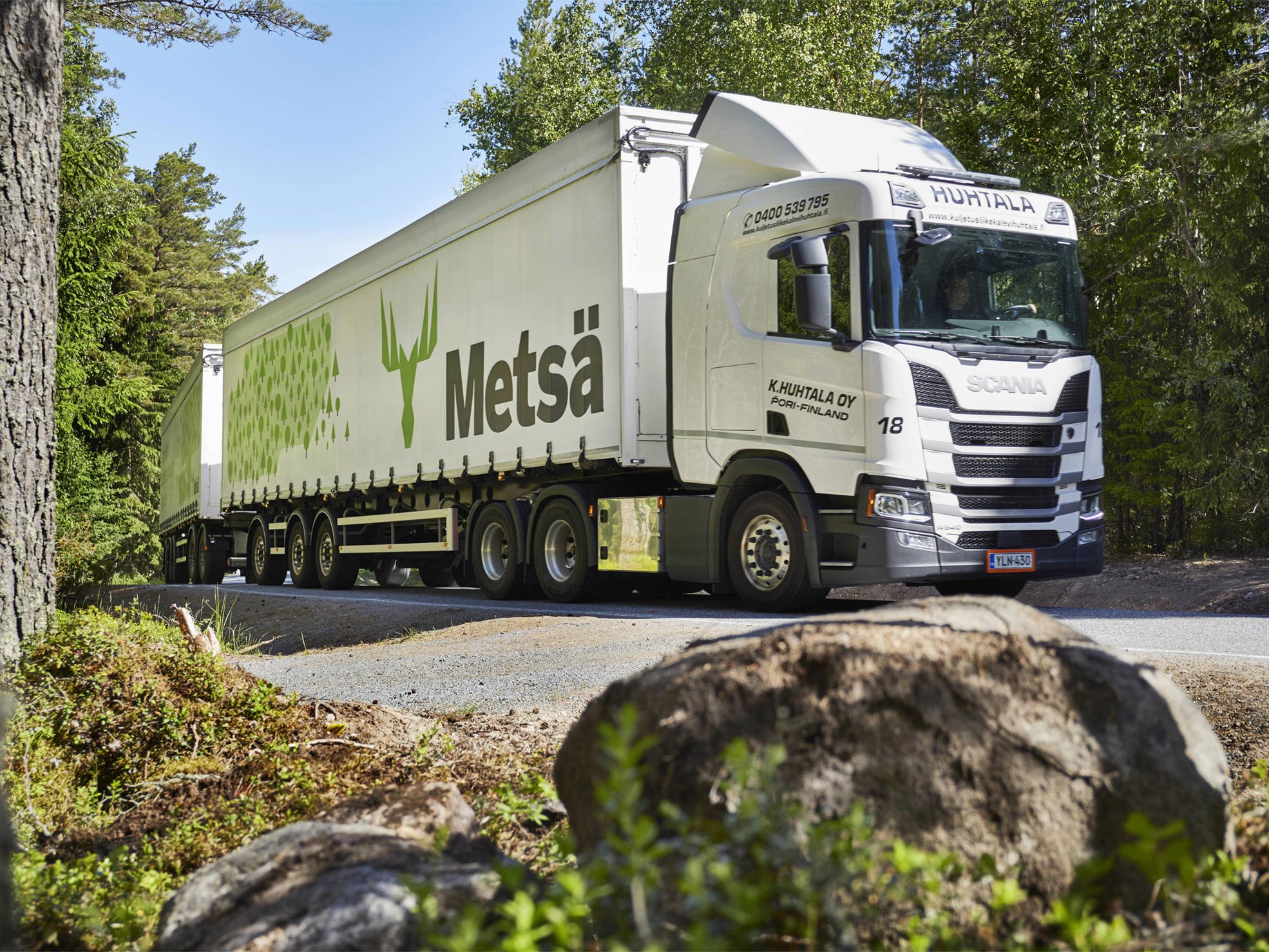 Sawn timber truck driving in a forest scenery