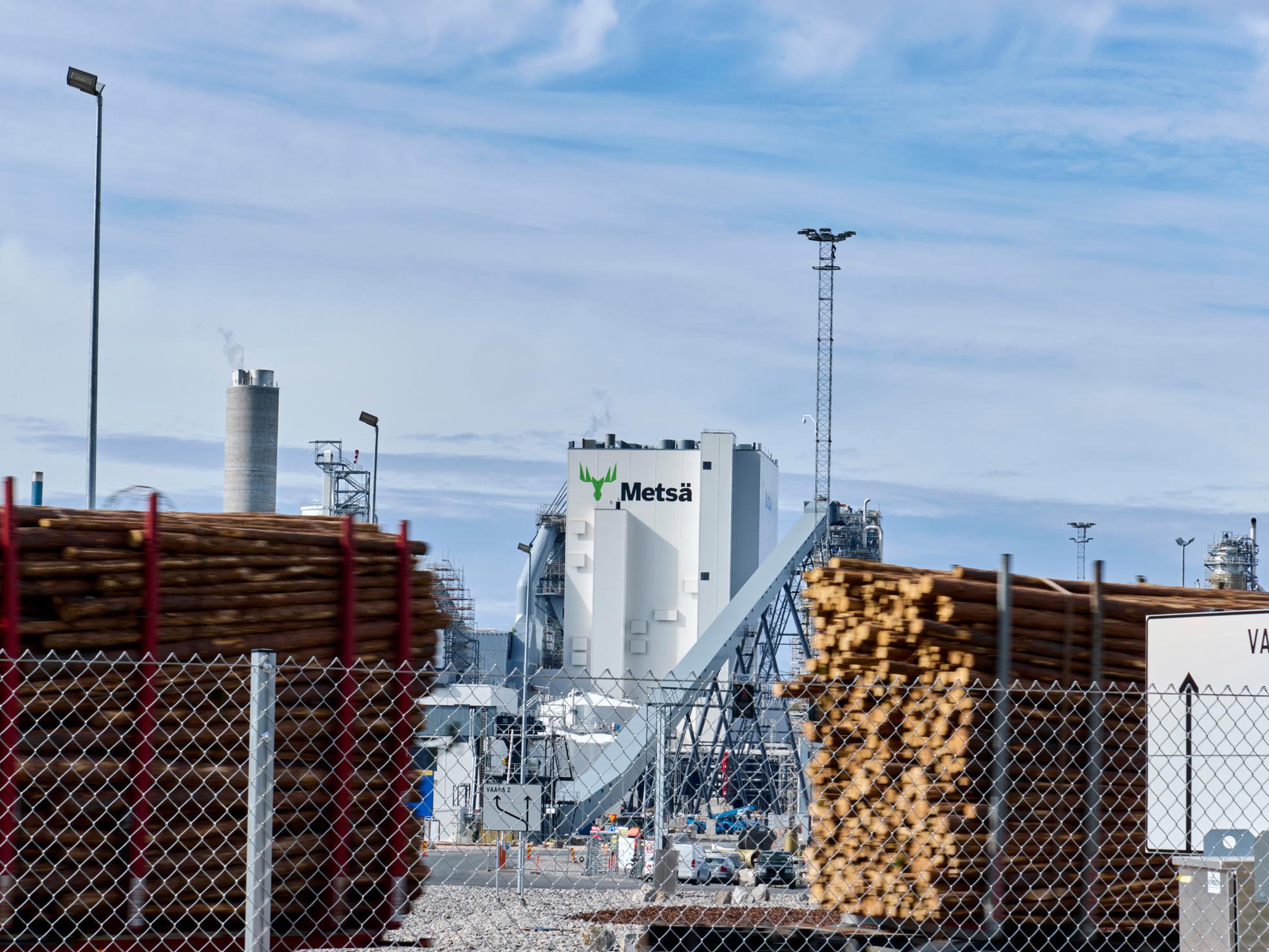 A lumber truck driving to the mill.