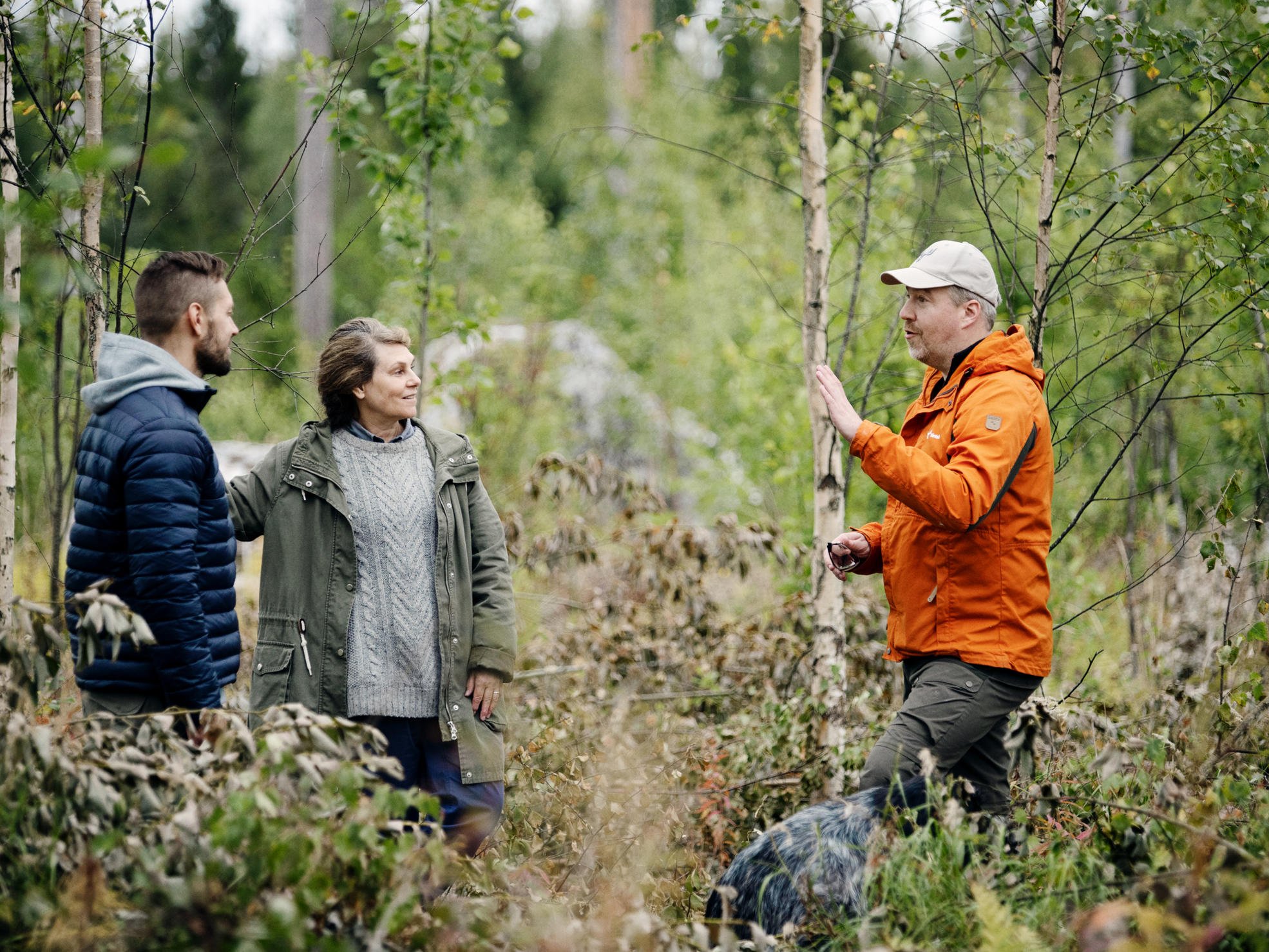 A forest specialist and forest owner walking in the forest.